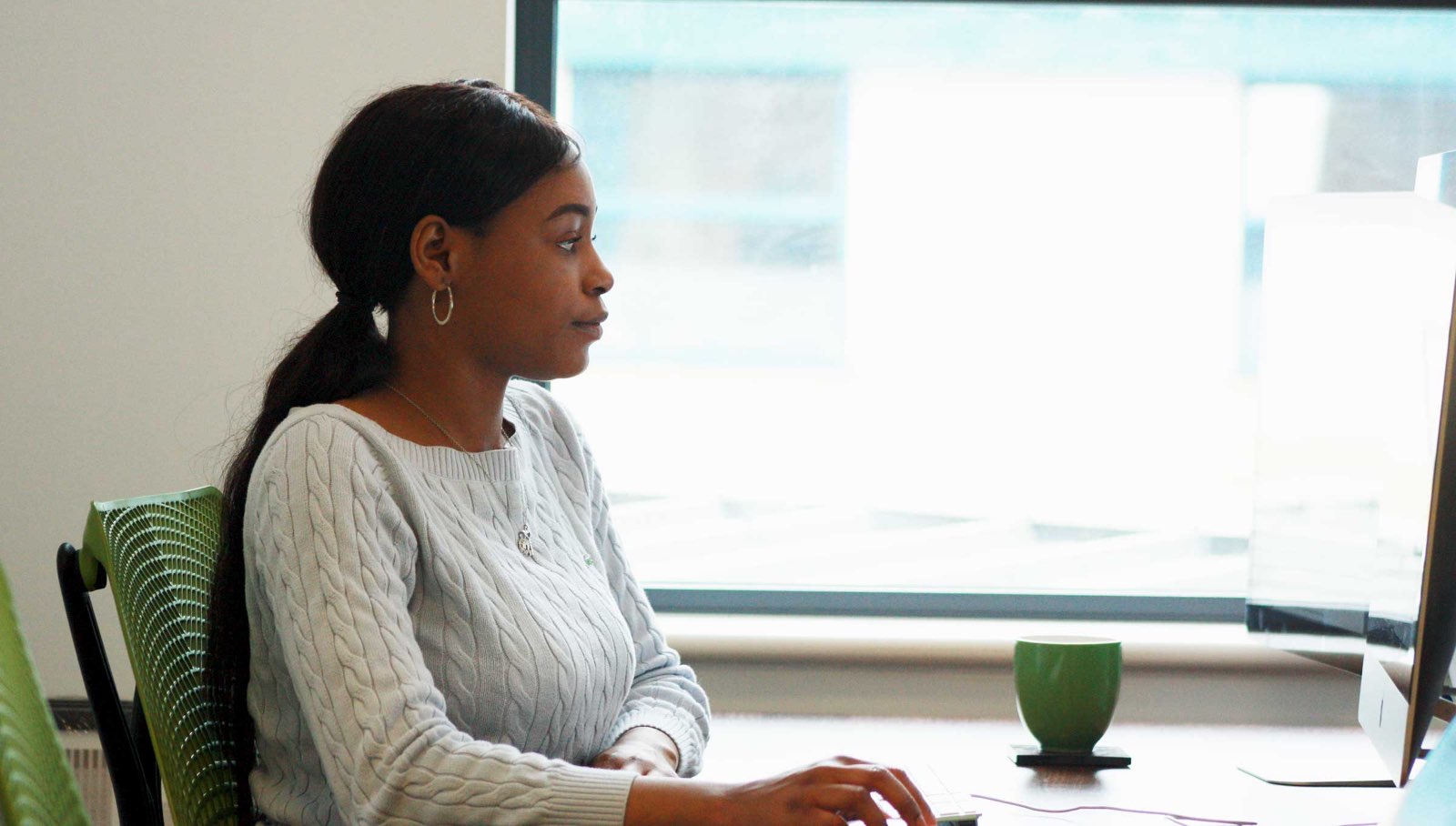 Photo of Joy Wagbara working in the Daymedia office