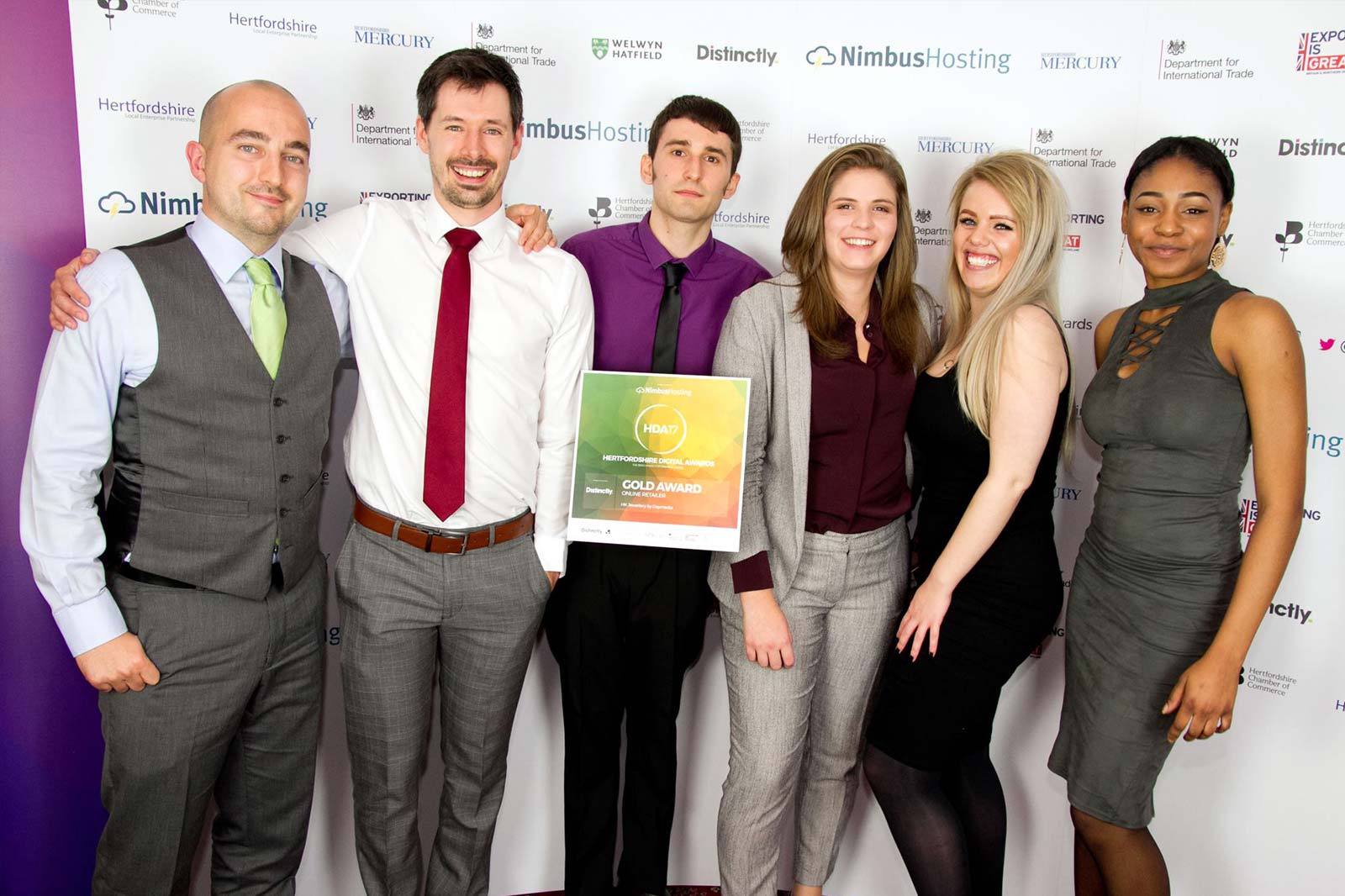 Photo of the Daymedia team at the Herts Digital Awards, holding the gold award plaque